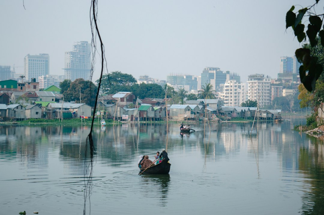 two people in a small boat on a river